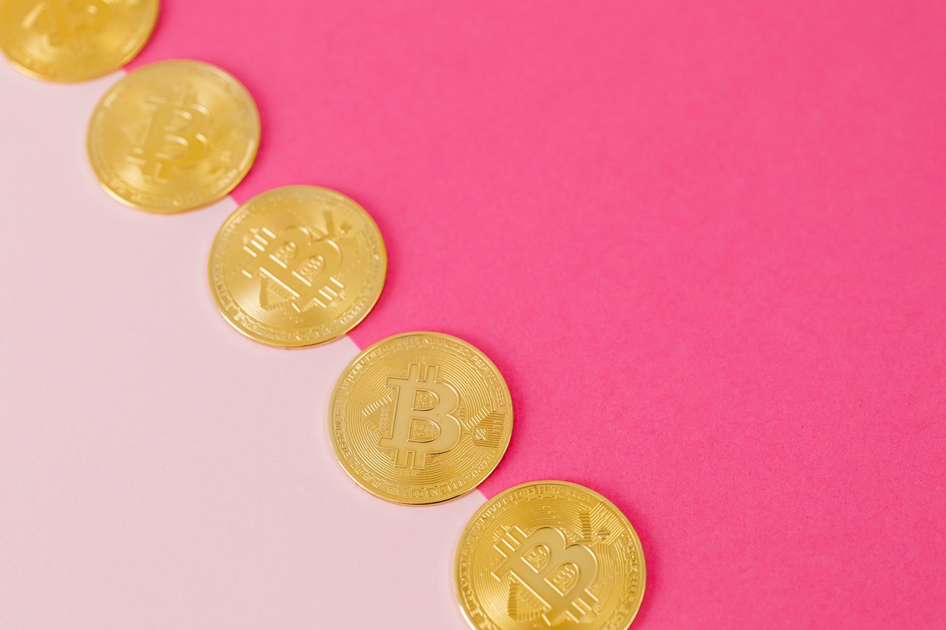 gold coins on pink surface